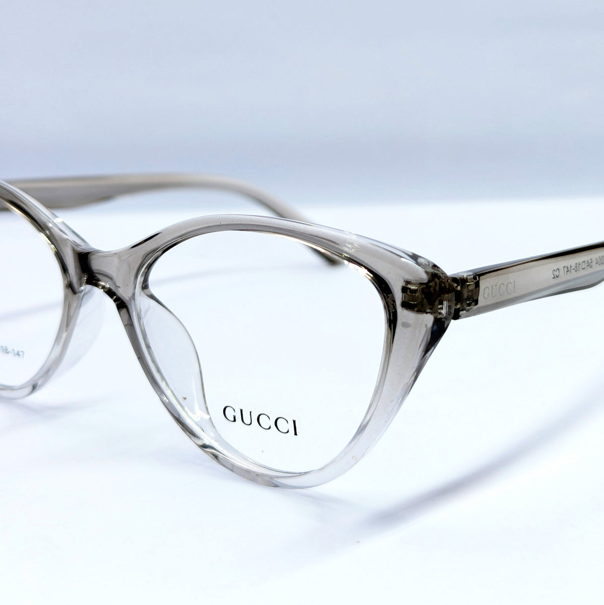 Gucci cat-eye eyeglasses in a translucent smoky gray acetate