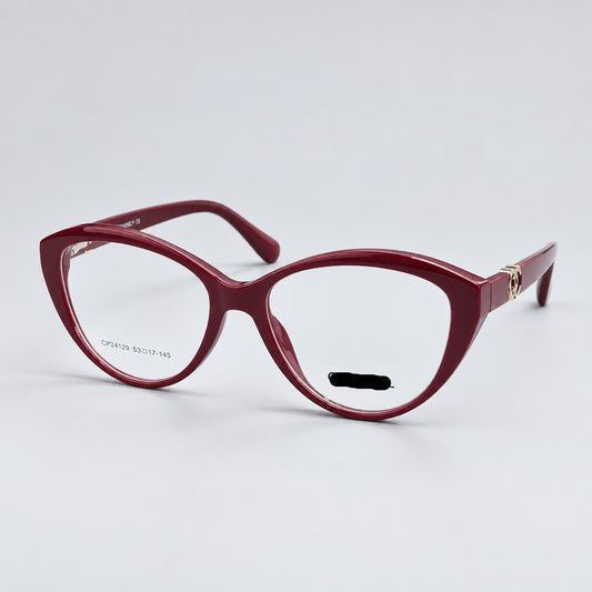 CHANEL Paris cat-eye eyeglasses in a translucent burgundy acetate, featuring gold metal hinges and the CHANEL logo on the lower right frame corner.