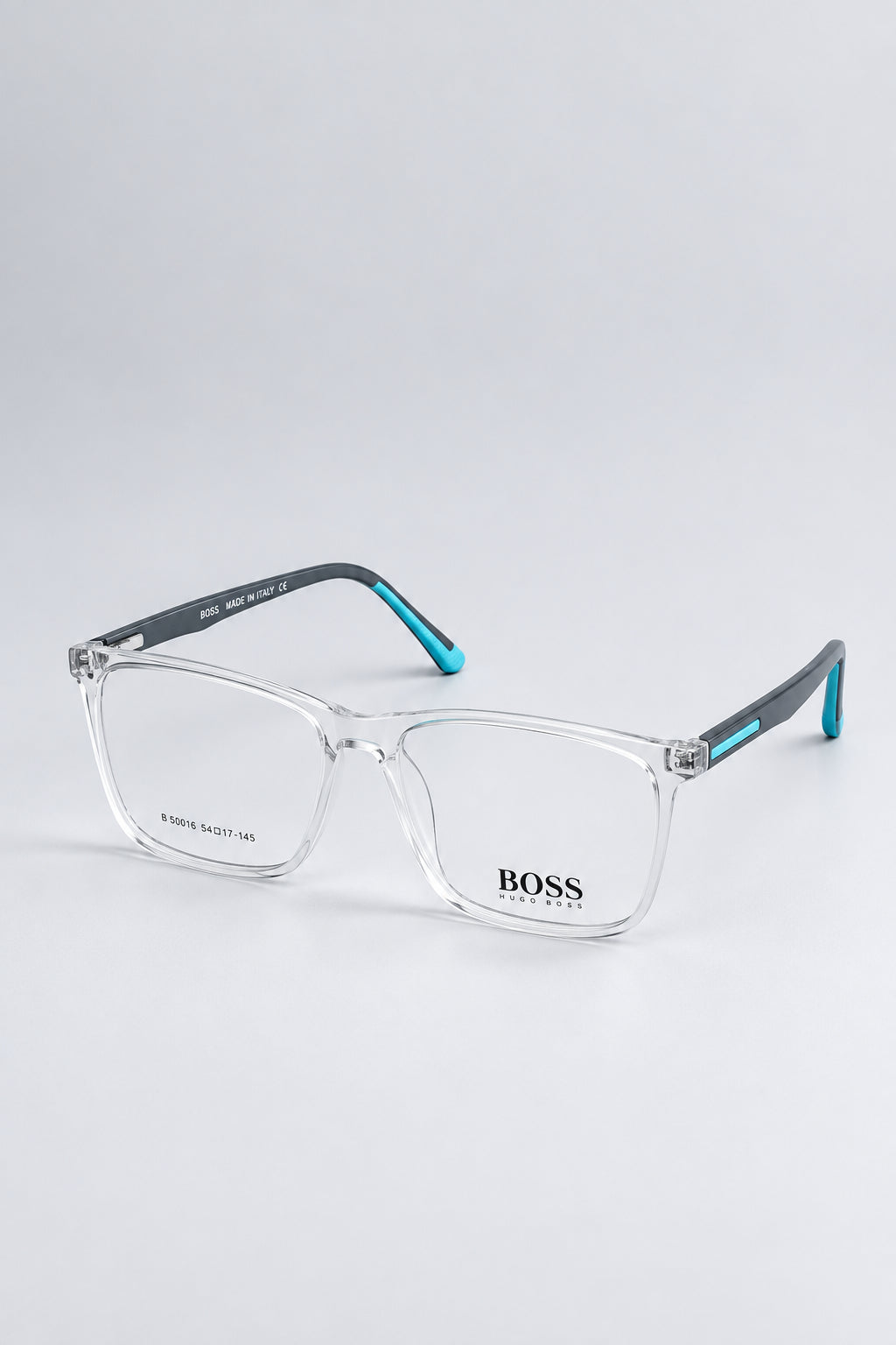BOSS clear acetate eyeglasses with gray temples and light blue accents, displayed on a light blue background.
