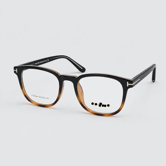Tom Ford eyeglasses with a dark brown and amber tortoiseshell acetate frame, shown on a light gray background.