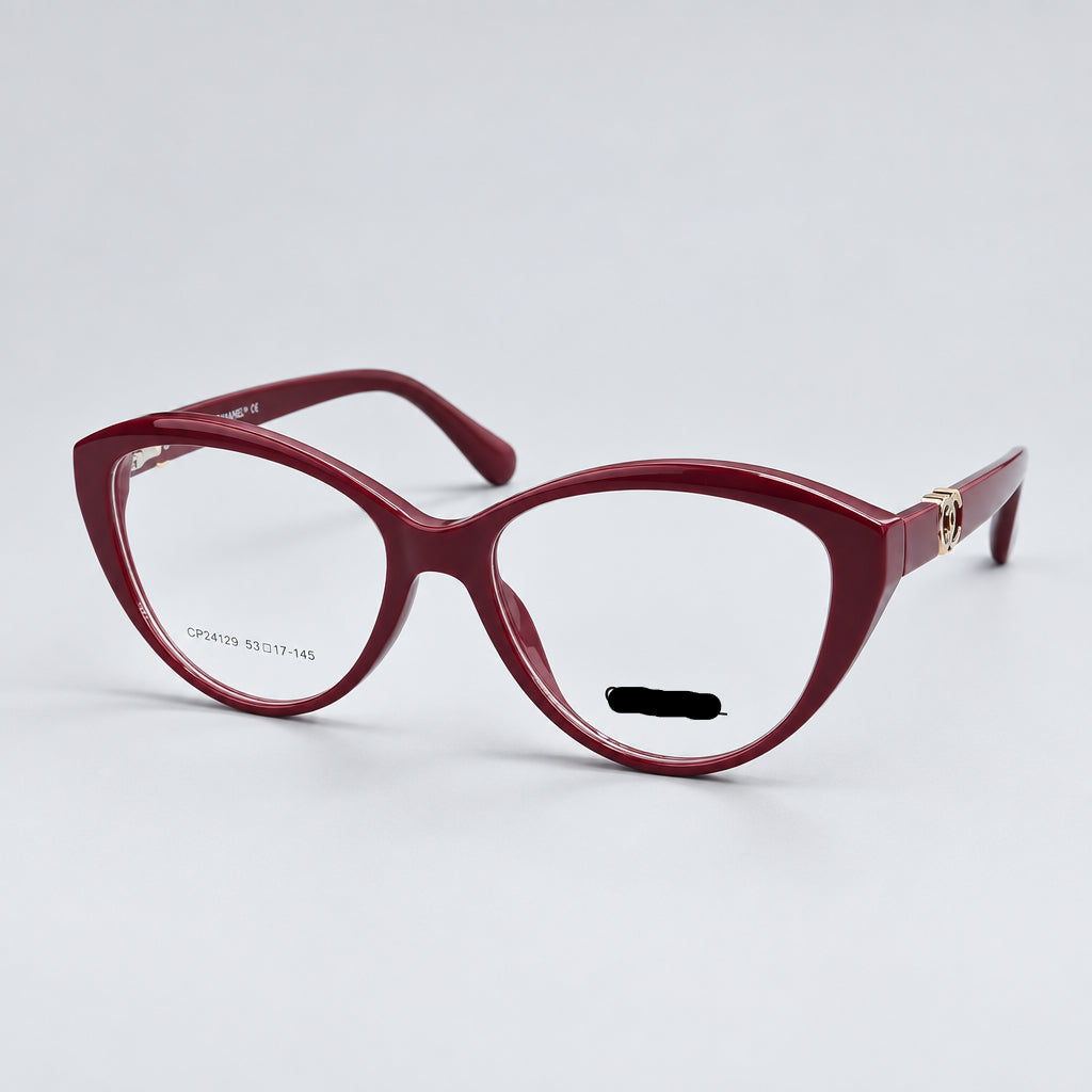 CHANEL Paris cat-eye eyeglasses in a translucent burgundy acetate, featuring gold metal hinges and the CHANEL logo on the lower right frame corner.