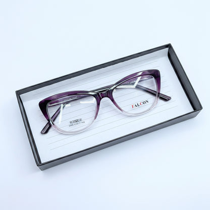 A pair of cat-eye eyeglasses with a purple-to-clear gradient acetate frame, resting inside a black presentation box on a white background.